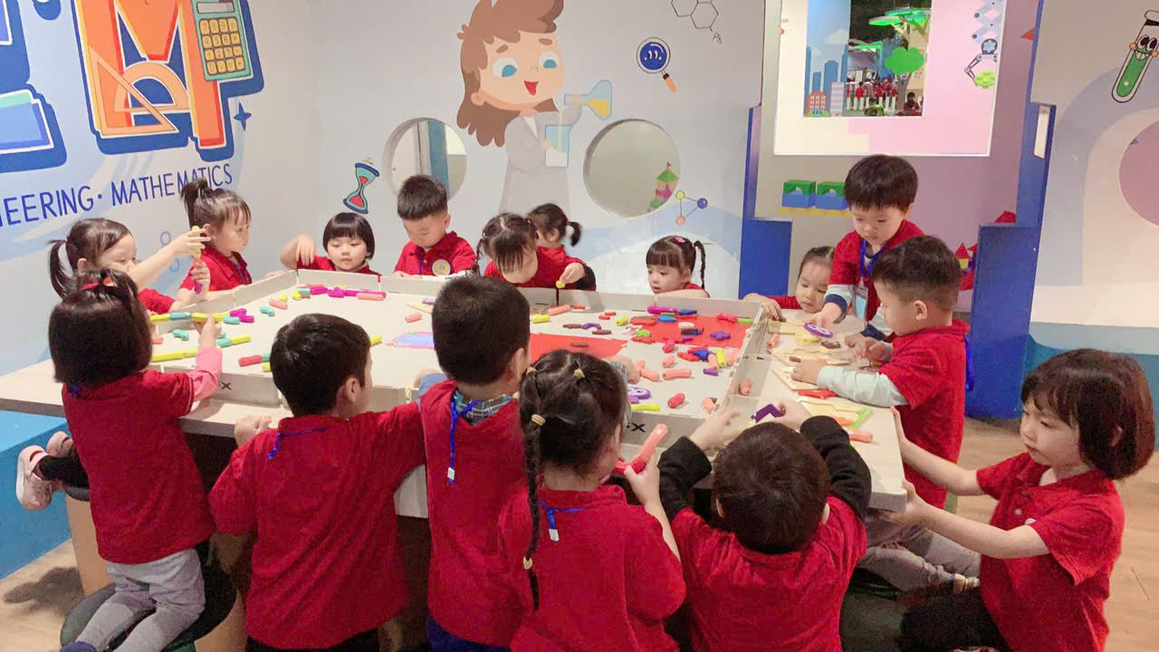 A group of children in red shirts

Description automatically generated