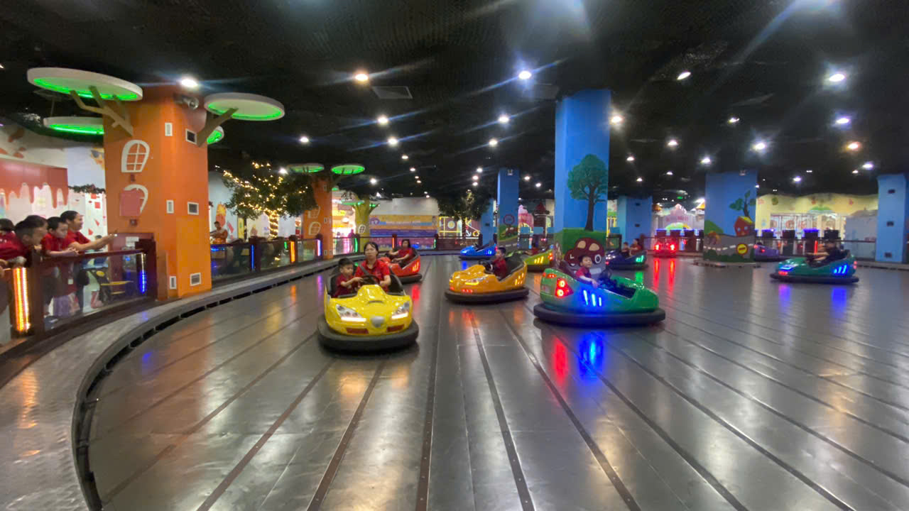 A group of people on bumper cars

Description automatically generated