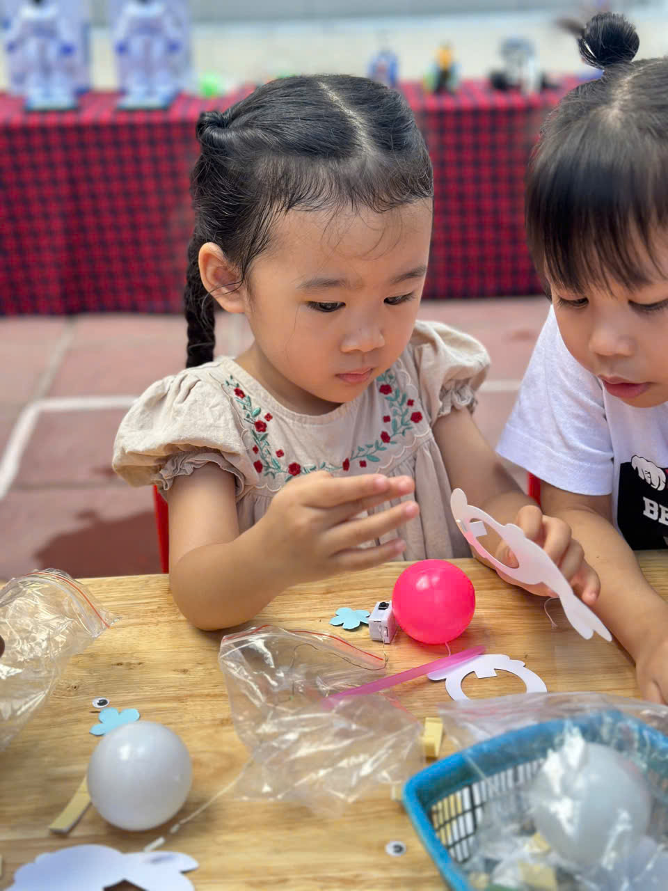 A child and child making crafts

Description automatically generated