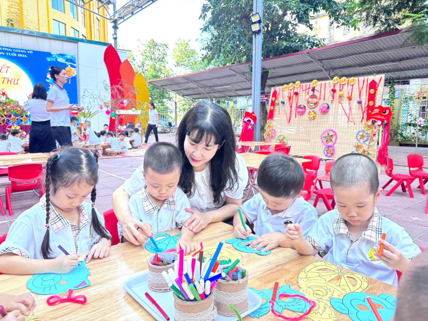 A group of children and a person sitting at a table with art

AI-generated content may be incorrect.