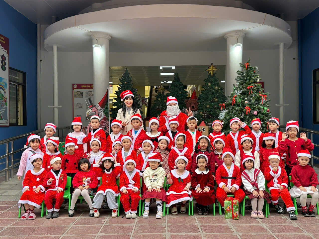 A group of children in red and white outfits posing for a photo

Description automatically generated