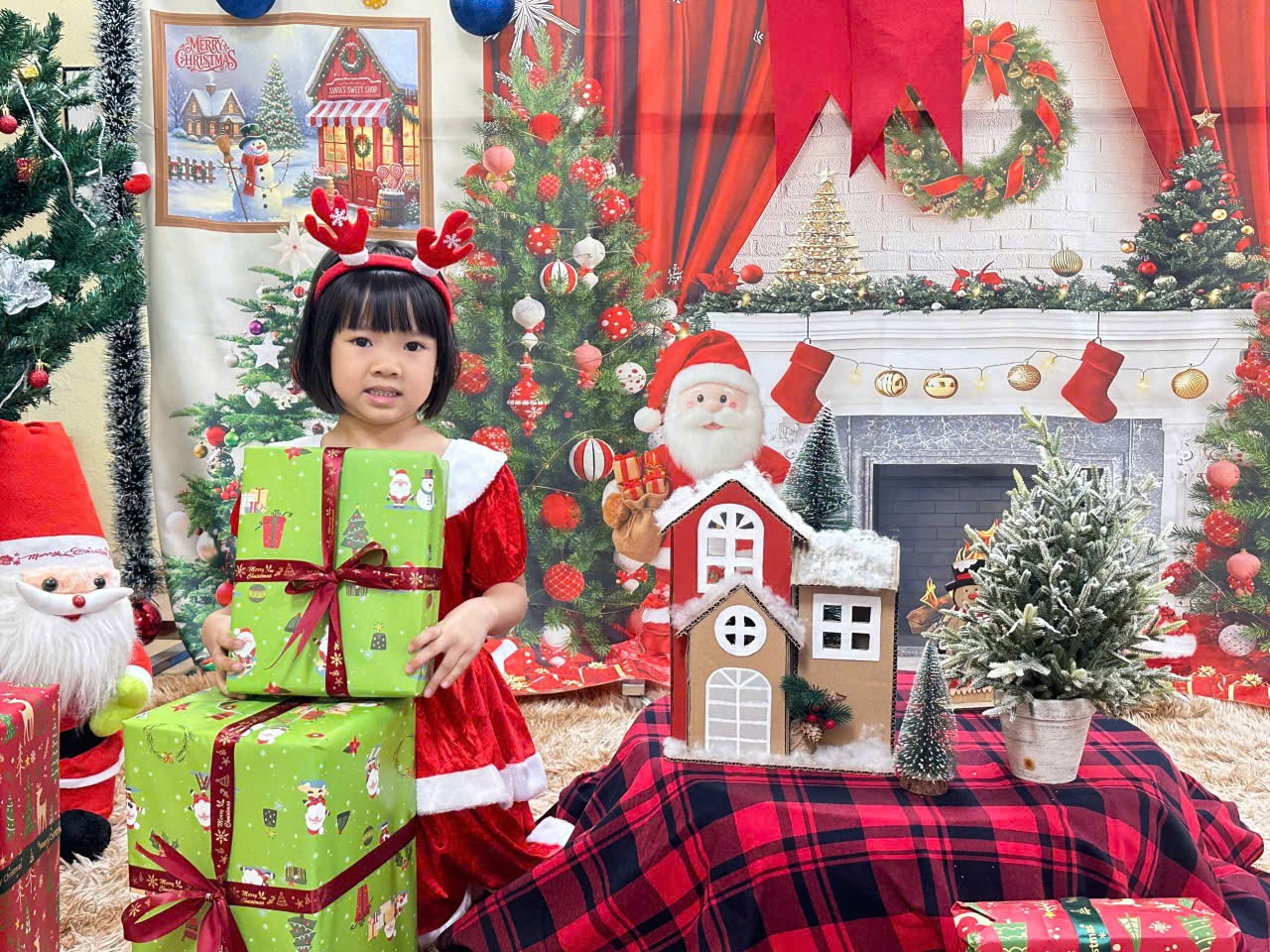 A child in a red dress holding presents

Description automatically generated