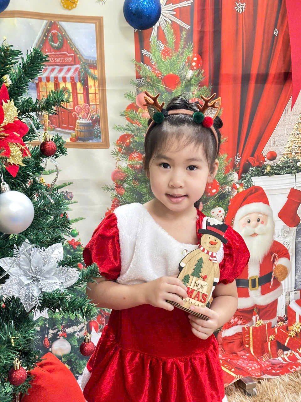 A child holding a snowman

Description automatically generated