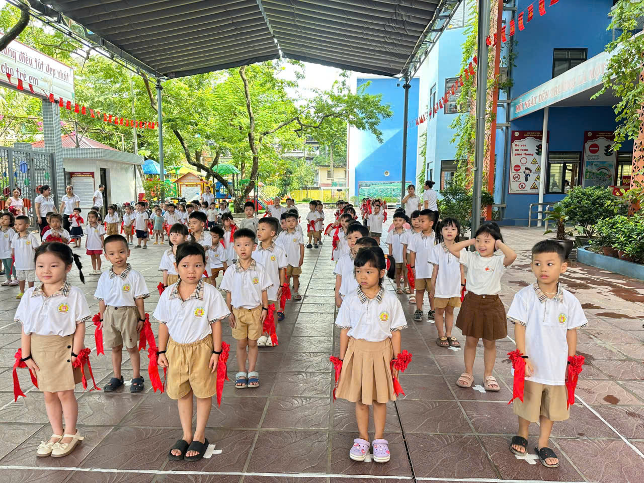 A group of children in school uniforms

Description automatically generated