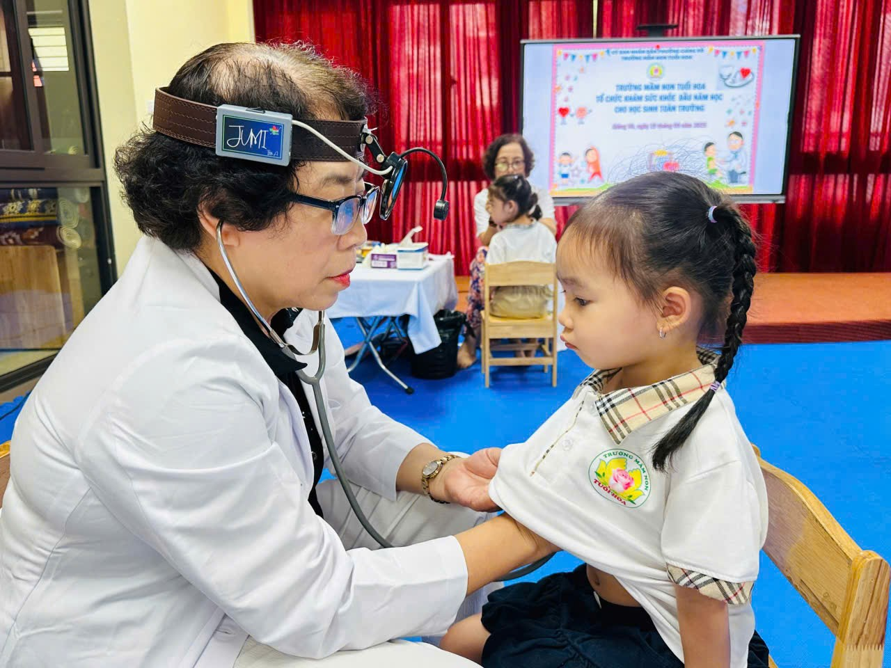 A doctor examining a child

Description automatically generated
