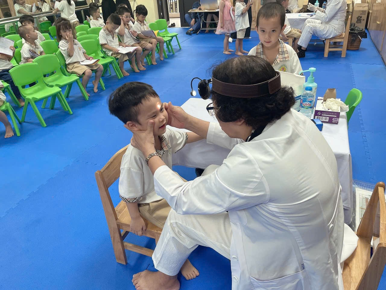 A person in white coat examining a child

AI-generated content may be incorrect.