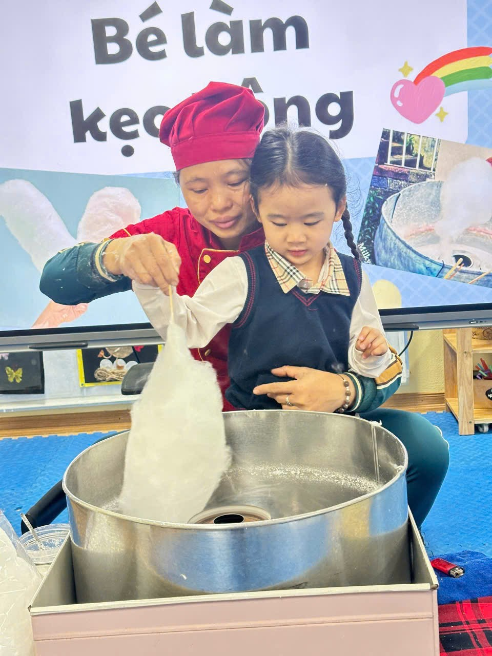 A child and a child in a lab

Description automatically generated