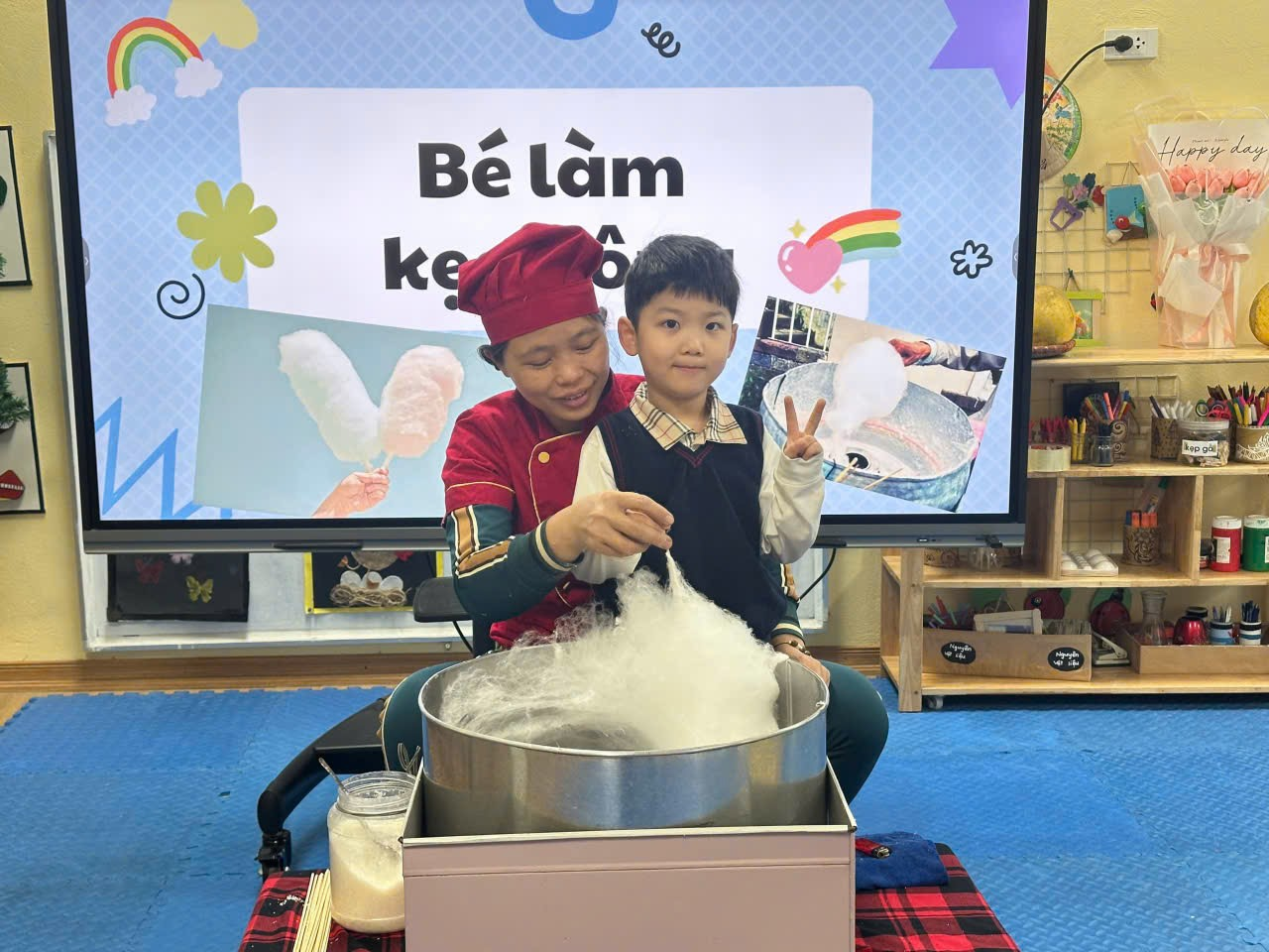 A person and child making cotton candy

Description automatically generated