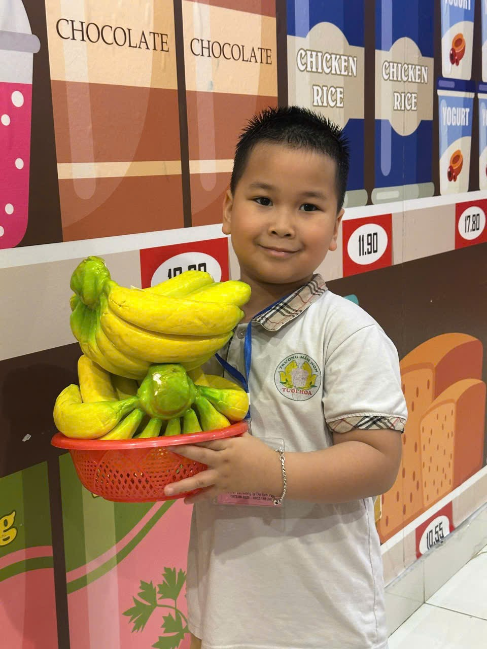 A child holding a bowl of bananas

Description automatically generated