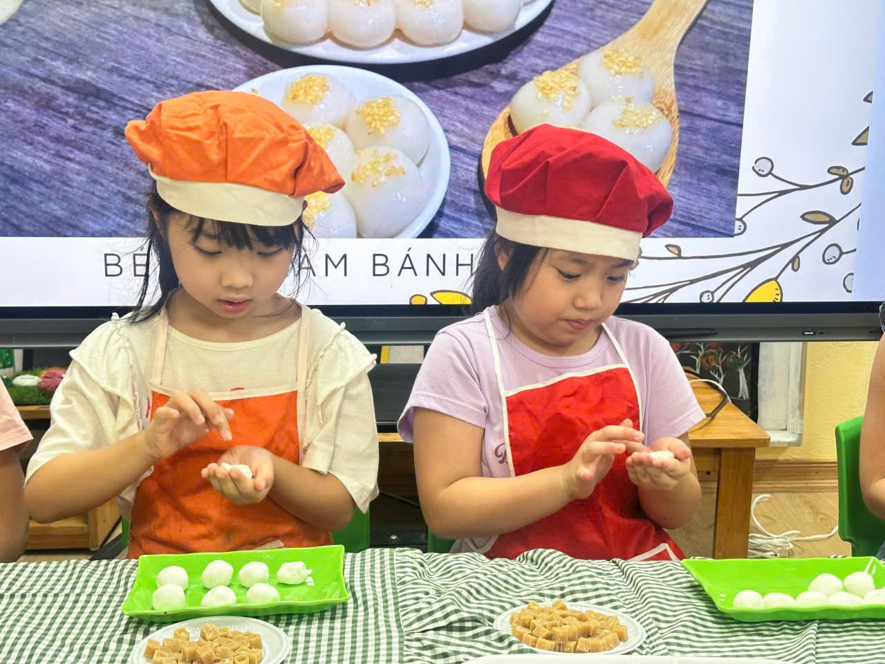 Two girls wearing chef hats and cooking

Description automatically generated